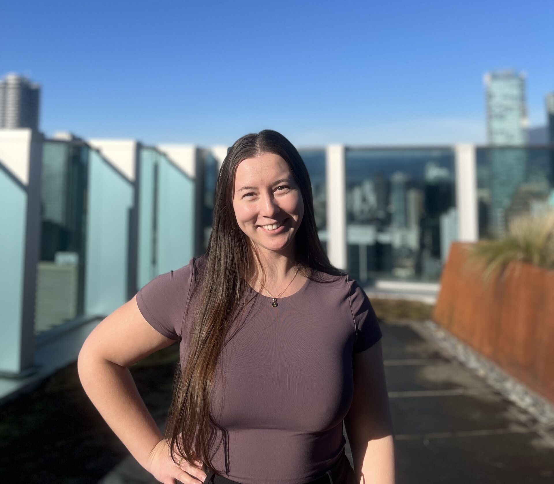 Woman standing with city view behind her
