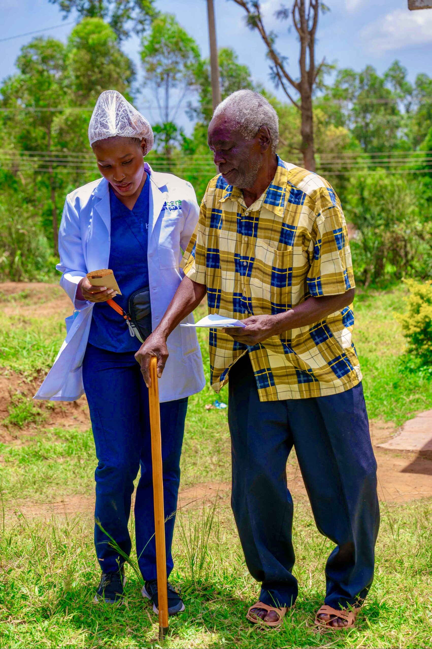 Elderly man being helped by a volunteer.