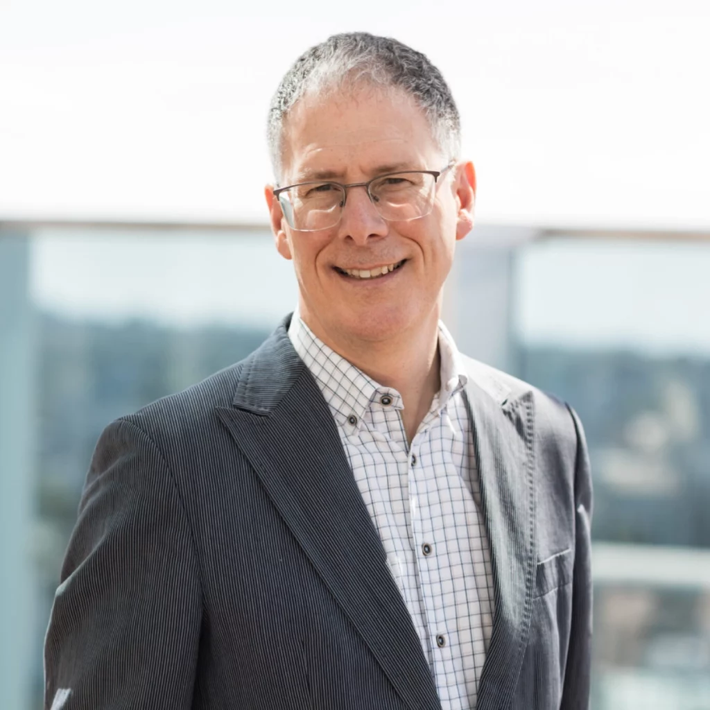 Malcolm Burrows in a suit, standing outside