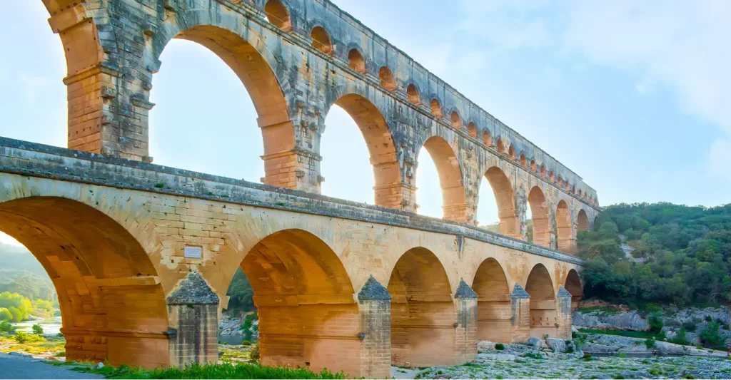 An ancient looking aqueduct over a body of water